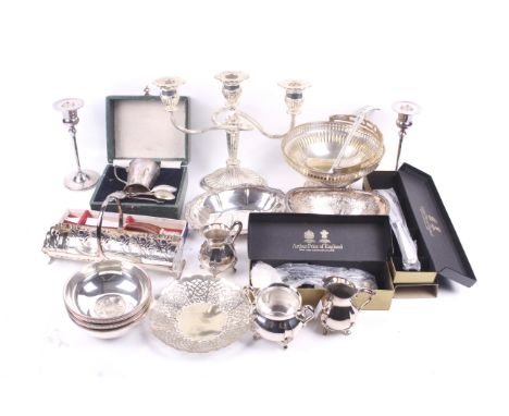 A collection of silver plated items. Including a pair of round candlesticks and three round dishes inset with coins, a straig