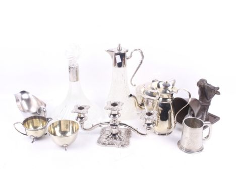 A collection of silverplate and metalware. Including a pair of glass claret jugs, a three piece tea service, a sauceboat, a c
