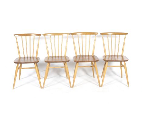 A set of four mid-century Ercol Hertiage Windsor dining chairs. With tapering legs and spindle back, a smooth curved top rail