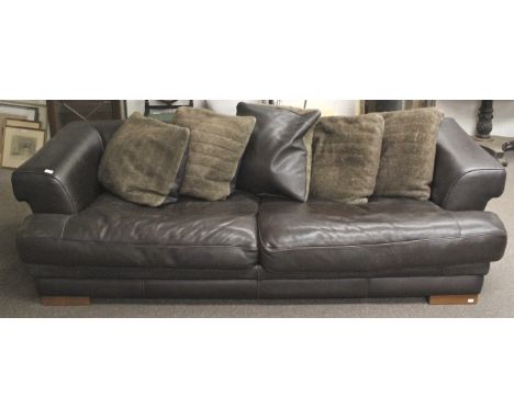 A large leather sofa. Upholstered with black pebble grain leather, having angled armrests and large wooden feet, together wit