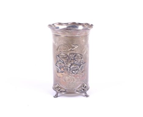 An Art Nouveau silver vase decorated with two groups of cherubs. With fluted rim, on four spread feet, base missing. Rubbed h