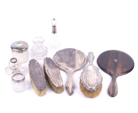 A collection of silver mounted dressing table items. Including a dressing table set of three brushes and a hand mirror, with 