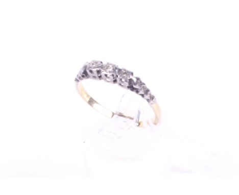 A three stone diamond ring. Set with three single cut diamonds of 0.05 carats estimated total weight. Tapering textured shoul