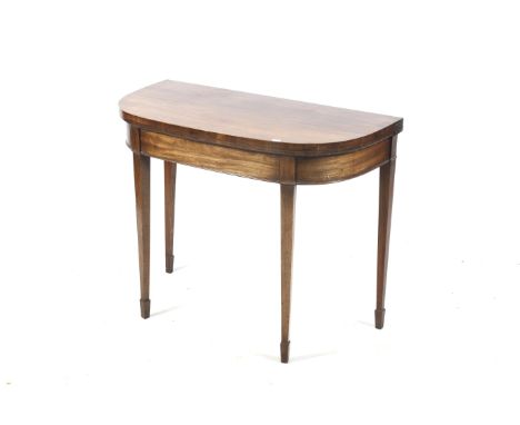 An Edwardian mahogany demi lune fold over card table. With square tapering supports terminating with spade feet. L92cm x D45c