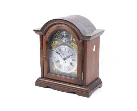 A Lincoln 31 Day 'Tempus Fugit' wood cased mantel clock. With an arched top. Silvered dial with Roman numerals. Movement stri