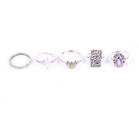A group of five silver and white metal ladies rings. Including an Art Deco style panel, amethyst cluster, and full eternity r