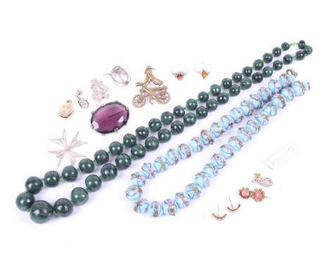 An assortment of costume jewellery. Including a malachite bead necklace, an oval locket, a baltic amber ring, white metal bro