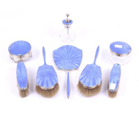 A silver and blue enamel dressing table set. Comprising four brushes, hand mirror, scent bottle, a silver and a glass lidded 