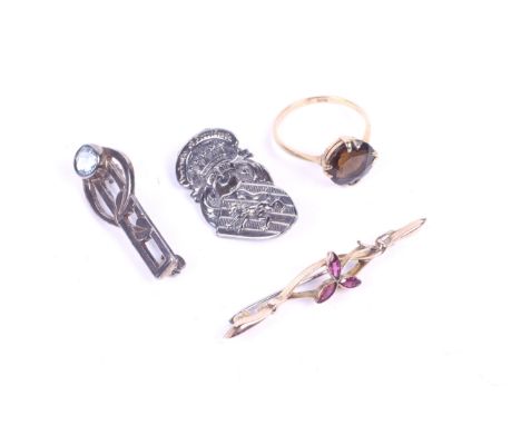 A 9ct gold ring, a gold brooch and two silver brooches. Comprising a 9ct gold ring set with brown stone; a 9ct gold brooch se