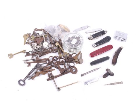 An assortment of collectables. Including penknives, keys a 1953 Coronation lighter, a propelling pencil and more
