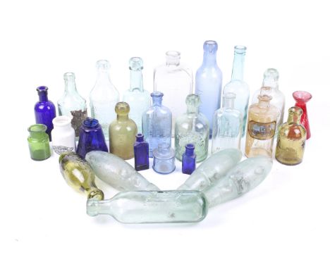 A collection of British vintage glass bottles. Clear, green and blue examples, including Leigh & Co, Salford 'Globe', Woodwar