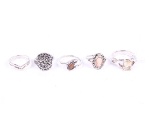 A group of five silver and white metal rings. Including Art Deco style, a cameo, etc. 