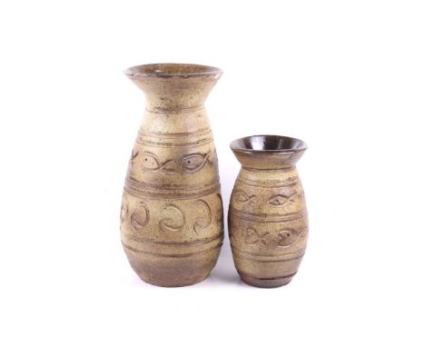 Two mid century studio art pottery vases. Both part of the same series, glazed in brown with engraved fish decoration, unmark