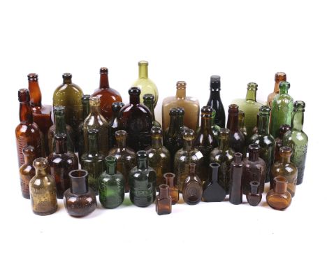 A collection of British vintage glass bottles. In a variety of sizes and amber, green and red, including medical and drinking