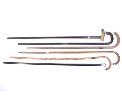Six walking sticks. Including a silver collared ebony example, L87cm, a silver topped ebony stick, L93cm, and a horn handled 