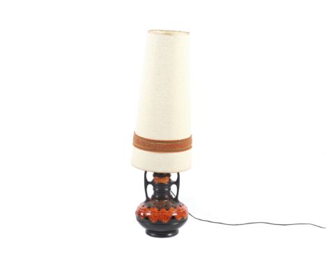 A mid-century West German 'fat lava' table lamp. Mottled brown and orange glaze, pierced with holes and double 'handles' with