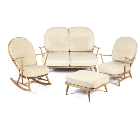 An Ercol mid-century 'blonde' four piece lounge suite. Including a Windsor elm and beech two seater sofa, an open arm chair, 