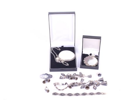 Two large silver mounted shell pendants and a set of Siamese jewellery. The pendants set with mother of pearl, back of the mo