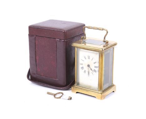 An early 20th century French carriage clock and case. The white dial with Roman numerals, having bevelled edge glass panels t