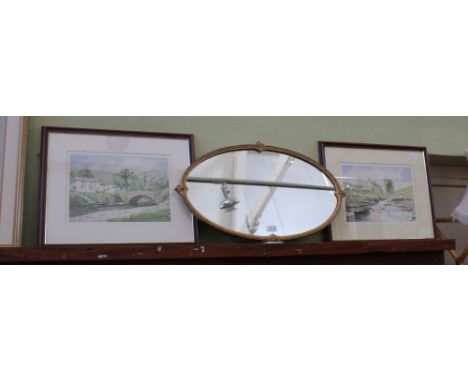 A PAIR OF LIMITED EDITION RURAL DWELLING PRINTS, together with an oval slender gilt framed wall mirror 