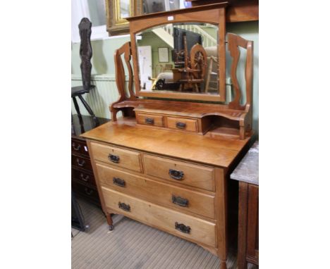 AN EARLY 20TH CENTURY DRESSING CHEST having adjustable mirrored back, over display shelf and twin jewellery drawers, the base