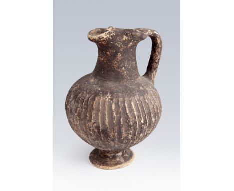 Etruscan Oinochoe, 3rd century BC. Black ceramic. Measures: 16 x 12,5 x 11,5 cm. The oinochoe is a vessel used to remove the 