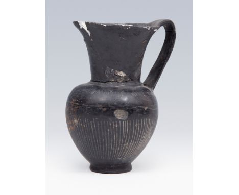 Etruscan jug. 6th century BC. In black bucchero. Measures: 14 x 10 x 9 cm. Etruscan jug made in a type of black pottery speci