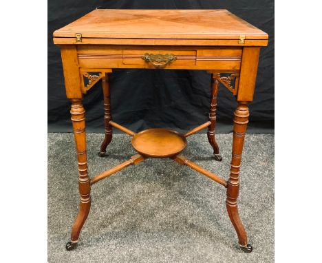 An Edwardian satin walnut envelope card table, tooled leather and baize surface, drawer to frieze, turned legs, dished X stre