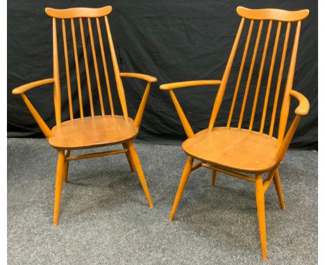 A pair of Ercol Goldsmith elm and beech carver chairs, designed by Lucian R Ercolani. 