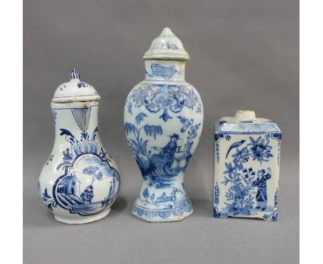 Delft blue and white tea caddy and cover, painted with figures and birds, together with a Delft sparrow beak jug and cover an