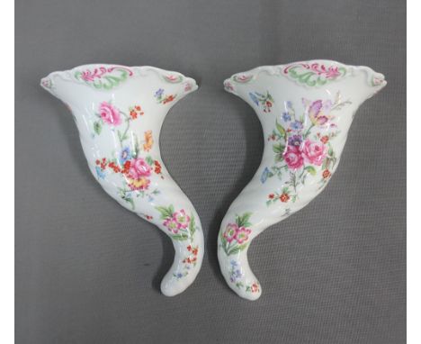 Pair of Royal Worcester porcelain cornucopia wall vases, with black printed backstamps, 25cm long (2) 