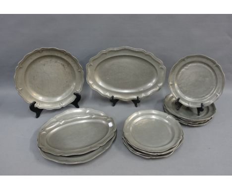 A collection of fourteen pewter plates and serving dishes, (14) 
