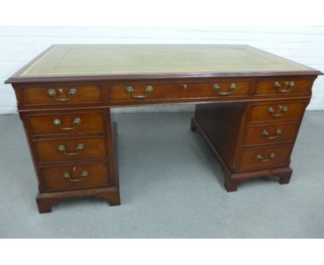 Mahogany veneered desk with green leather skivver and an arrangement of nine drawers with bracket feet, 71 x 154cm 