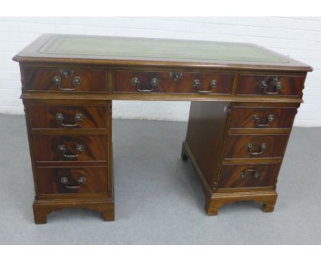 Mahogany veneered desk with green leather skivver and arrangement of nine drawers, on bracket feet, 80 x 122cm  