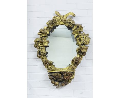 Floral giltwood mirror with pier shelf, the oval plate surmounted with a ribbon swag within a surround of mixed flowers and f