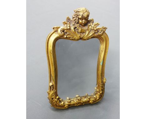 Gilt framed cherub mirror, with rectangular plate and easel strut back, 28 x 18cm 