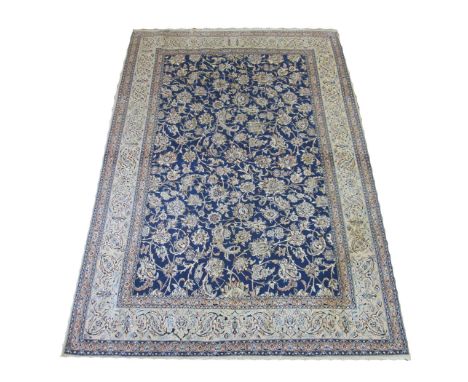 EXTREMELY FINE PART SILK NAIN CARPET, 230cm x 160cm, all over palmettes and vine design on a powder blue field within corresp