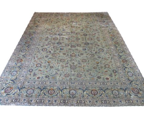 FINE KASHAN CARPET, 425cm x 322cm, all over design of palmettes and scrolling vines on a jade field within multiple correspon