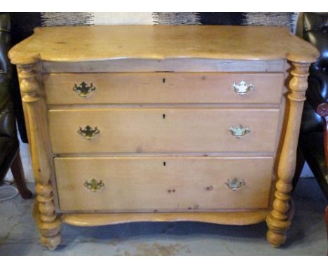 COMMODE, 19th century Continental pine, shaped top over three graduated drawers and columns, 121cm W x 51cm D x 90cm H.