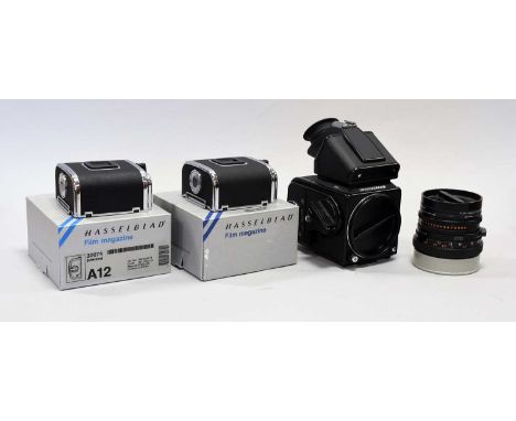 Hasselblad 501C Camera no.17ET12612 with prism viewer and film back; Carl Zeiss T* Planar f2.8 80mm lens and two Film Magazin