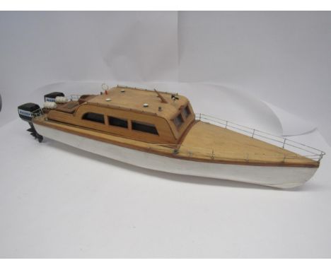 A kit built wooden model power boat, fitted with Hitec HS-500 servo and pair of Kyosho Corporation 'Jackson' outboard motors,