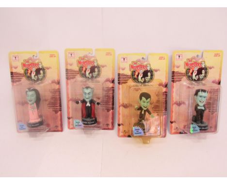 The Munsters- A set of four unopened carded Little Big Heads The Munsters figures by Sideshow Toy, to include Lily, Herman, G