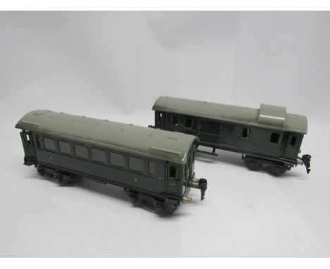Two Marklin tinplate 0 gauge model railway bogie coaches in green livery, comprising 17540 baggage car with four opening door