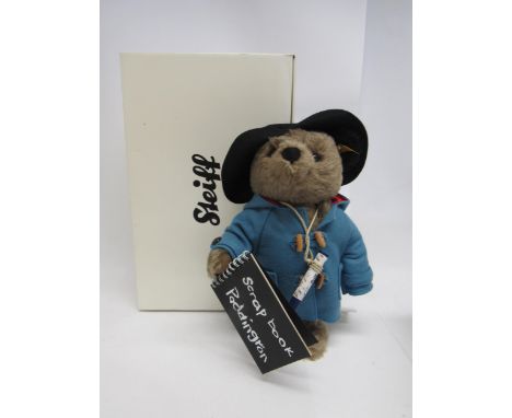 A boxed Steiff 354731 Paddington articulated mohair teddy bear wearing blue duffle coat and black hat, with scrap book and cr
