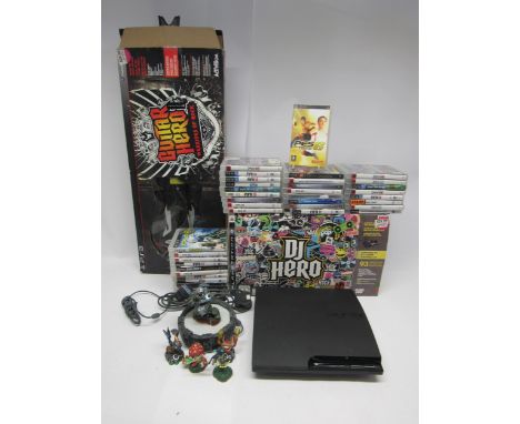 A Sony PlayStation PS3 computer games console with DJ Hero turntable kit, Guitar Hero Warriors Of Rock guitar, Skylanders Por