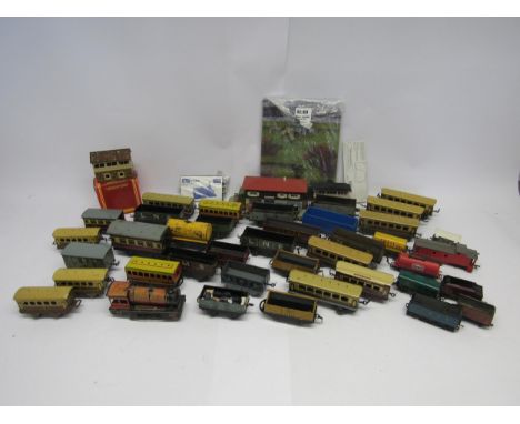 A collection of assorted 0 gauge model railway rolling stock and a smaller quantity of 00 gauge rolling stock and accessories
