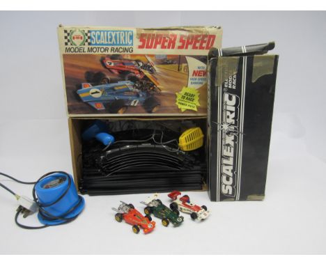 A Scalextric Super Speed slot racing set box containing three cars, two hand throttles and a quantity of track. Together with