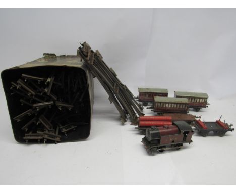 An unboxed playworn Hornby 0 gauge model railway clockwork LMS 0-4-0 locomotive no. 2270, three passenger coaches, three good