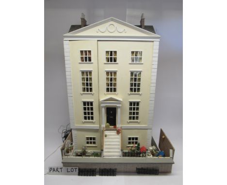 A 20th Century dolls house in the form of a Georgian townhouse, the front opening to reveal six rooms and three hallways over