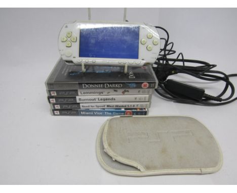 A Sony PlayStation PSP handheld computer games console with soft case, adapter, four games to include Lemmings, Burnout Legen